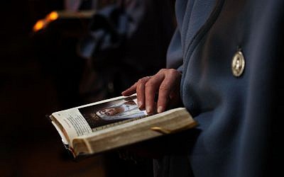 A Catholic nun attends the Washing of the Feet ceremony during the Easter Holy Week, inside the Church of the Holy Sepulchre. (photo credit: AP)