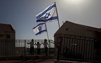 Israeli flags fly over the Ulpana outpost on the outskirts of Beit El, near Ramallah. (photo credit: AP)