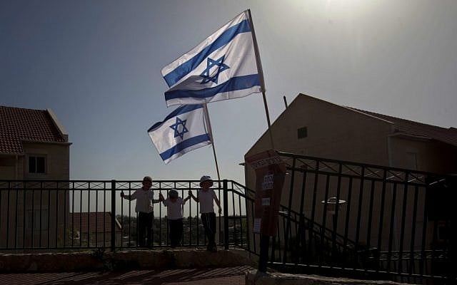 Israeli flags fly over the Ulpana outpost on the outskirts of Beit El, a settlement in the West Bank (photo credit: AP)