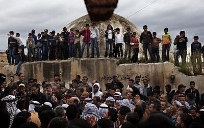 Palestinians surround the groom Thaer Qasem during his wedding with Maha Surougi in the West Bank village of Deir Istiya, near Nablus, on Thursday. (photo credit: AP/Bernat Armangue)