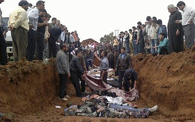 This citizen journalist image obtained by AP shows a mass burial of people allegedly killed in the shelling in Taftanaz, Syria. AP cannot independently verify the location, content, or authenticity of the photo. (photo credit: AP)