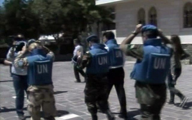 United Nations observers visit Homs on Saturday. (photo credit: AP/Syria TV)
