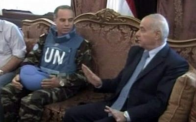 U.N. observer team leader Col. Ahmed Himmiche, left, meeting with the governor of Homs, April 21, 2012.  (photo credit: AP Photo/Syria TV via AP video) 