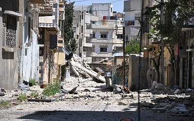A residential neighborhood in Homs following a government bombardment (photo credit: AP) A residential neighborhood in Homs following a government bombardment (photo credit: AP)