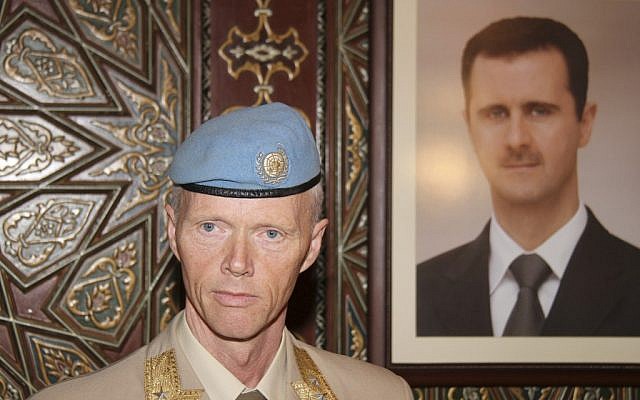 Norwegian General Robert Mood stands near a portrait of Bashar Assad in Damascus (photo credit: AP/Bassem Tellawi)