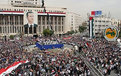 Pro-Syrian government demonstrators rally in Damascus, on Saturday (photo credit: AP / Bassem Tellawi)