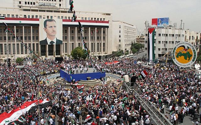 Pro-Syrian government demonstrators rally in Damascus, on Saturday (photo credit: AP / Bassem Tellawi)