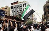 Syrian mourners carry the body of Rama Saada, 9, who was shot by Syrian forces in Damascus on Wednesday (photo credit: AP Photo)