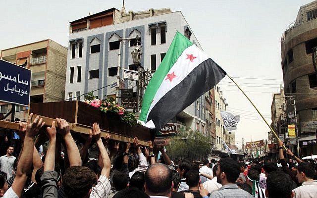 Syrian mourners carry the body of Rama Saada, 9, who was shot by Syrian forces in Damascus on Wednesday (photo credit: AP Photo)