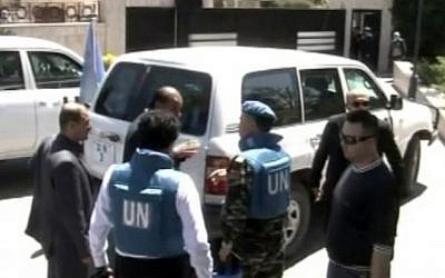 UN observers visiting Homs, Syria, on Saturday. (photo credit: AP/Syria TV via AP video)
