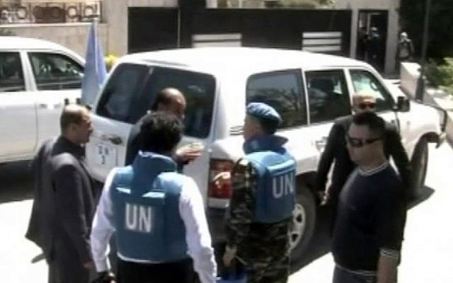 UN observers visiting Homs, Syria, on Saturday. (photo credit: AP/Syria TV via AP video)