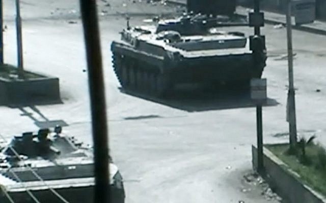 Amateur video released by Douma City purports to show Syrian military tanks at the Damascus suburb of Douma, Syria. (photo credit: AP/Shaam News Network via AP video)