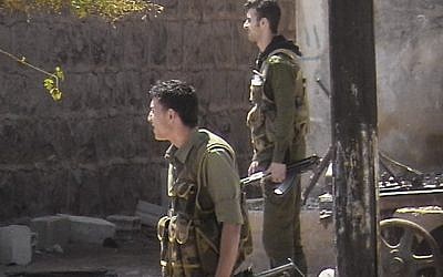 Syrian security forces in a neighborhood in Daraa (photo credit: AP Photo/Local Coordination Committees in Syria)