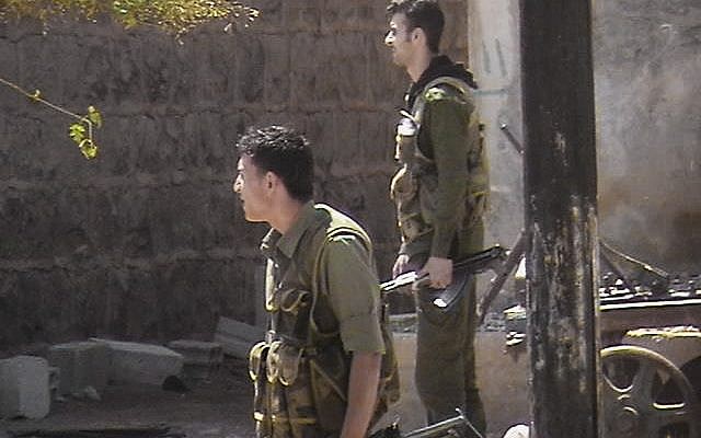 Syrian security forces in a neighborhood in Daraa (photo credit: AP Photo/Local Coordination Committees in Syria)