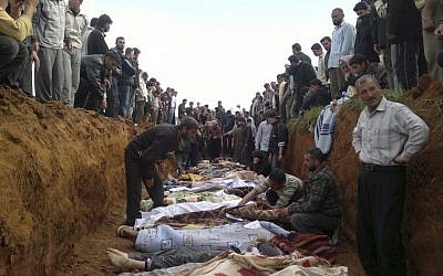 This citizen journalist image obtained by the Associated Press on Friday, April 6, 2012. purportedly shows a mass burial of people allegedly killed in recent shelling in Taftnaz, Syria. (photo credit: AP)