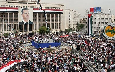 Pro-Syrian government demonstrators hold a rally in Damascus to commemorate the 65th anniversary of the foundation of the ruling Baath Arab Socialist Party, April 7, 2012. (photo credit: AP Photo Bassem Tellawi) Pro-Syrian government demonstrators hold a rally in Damascus to commemorate the 65th anniversary of the foundation of the ruling Baath Arab Socialist Party, April 7, 2012. (photo credit: AP Photo Bassem Tellawi)