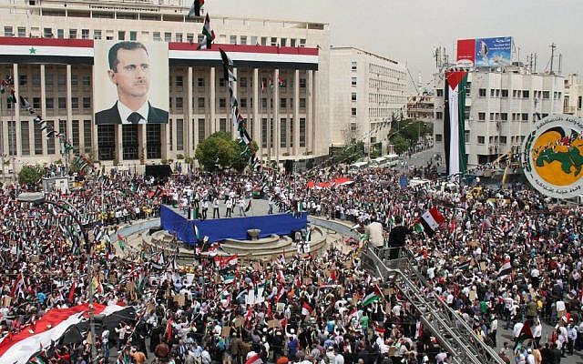 Pro-Syrian government demonstrators hold a rally in Damascus to commemorate the 65th anniversary of the foundation of the ruling Baath Arab Socialist Party, April 7, 2012. (photo credit: AP Photo Bassem Tellawi)