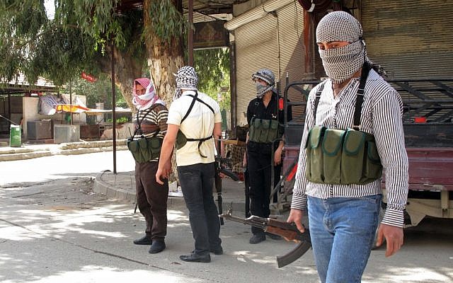 Free Syrian Army fighters gather on a corner during fighting with Syrian troops in a suburb of Damascus. (photo credit: AP) Free Syrian Army fighters gather on a corner during fighting with Syrian troops in a suburb of Damascus. (photo credit: AP)