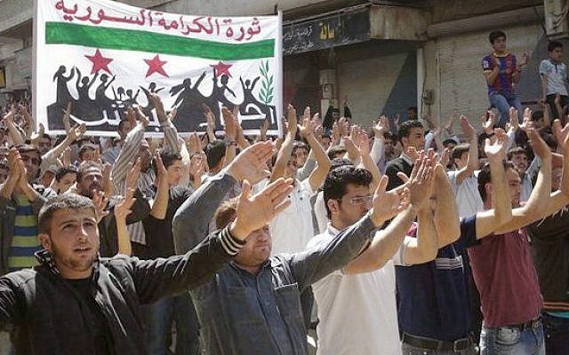 Syrian opposition demonstrators in Idlib in early April (photo credit: AP)