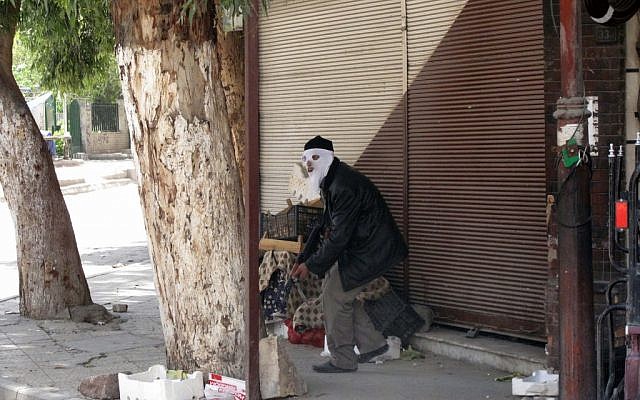 A Free Syrian Army fighter in a suburb of Damascus, Syria (photo credit: AP) A Free Syrian Army fighter in a suburb of Damascus, Syria (photo credit: AP)