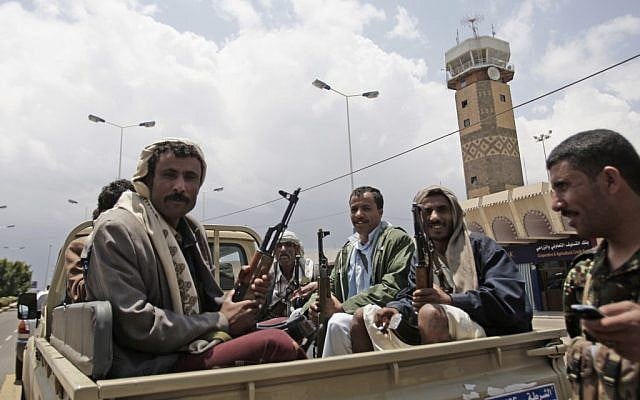 Yemeni policemen sit in a pickup truck in front of Sanaa's International airport. (photo credit: AP/Hani Mohammed)