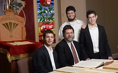 Rabbi Areyah Kaltmann and his sons. Kaltmann bought rare Talmuds the U.S. Army authorized for publication. (photo credit: AP/HO, Lorn Spolter)