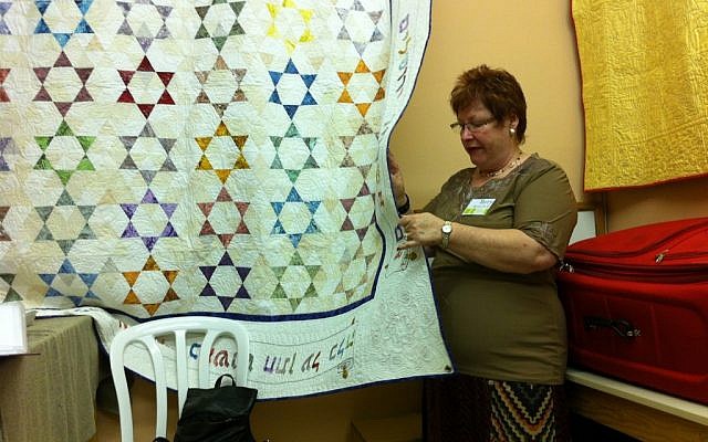 Terry Mowszowski examines one of the quilts destined for Benji's Home (courtesy: Terry Mowszowski)
