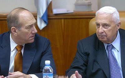 Ehud Olmert and Ariel Sharon, at a 2004 cabinet meeting. (photo credit: Sharon Perry/Flash 90/File.