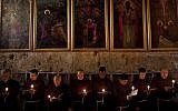 Catholic clergy attend a procession during Holy Saturday inside the Church of the Holy Sepulchre (photo credit: AP/Bernat Armangue)