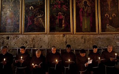 Catholic clergy attend a procession during Holy Saturday inside the Church of the Holy Sepulchre (photo credit: AP/Bernat Armangue)