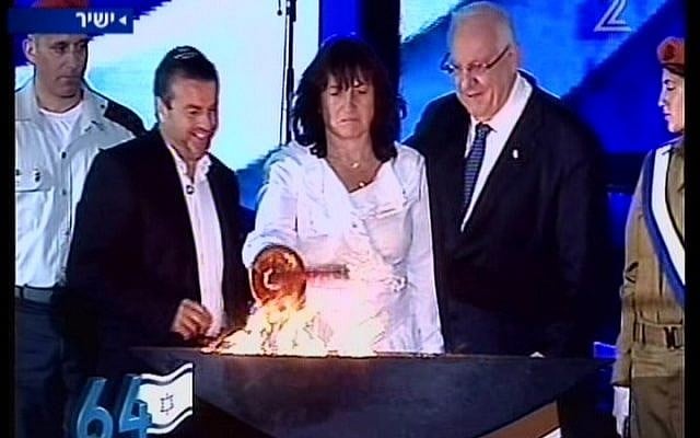 Sigalit Betzaleli lights a torch at the official opening ceremony of Independence Day on Mount Herzl on Wednesday night. Betzaleli's daughter Hila, an officer in the Medical Corps, was killed in an accident at the same spot last week. (photo credit: Channel 2 News)