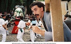 The 2006 film 'Borat' depicted an absurd 'Running of the Jew' ceremony. In Mexico, a newspaper is reporting on a genuine 'Burning of the Jews' event. (Illustrative photo credit:  Ruben Fleischer/20th Century Fox)