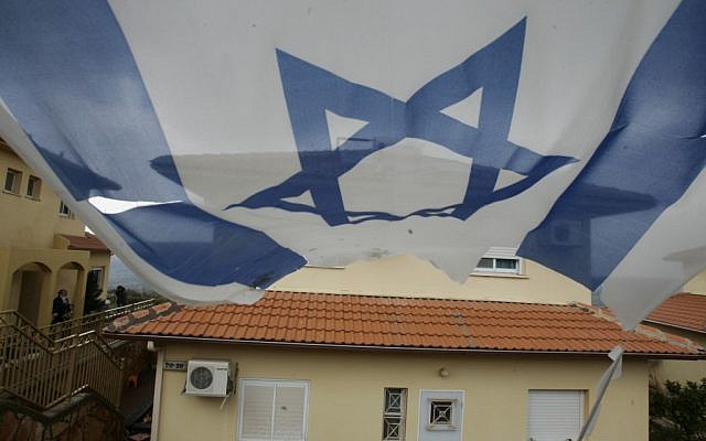 A flag hangs near a house in the settlement of Bruchin (photo credit: Uri Lenz/Flash90)
