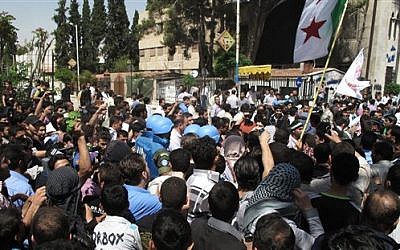 Syrian protestors gather around U.N. observers during their visit in Douma near the capital of Damascus, Syria, April 23, 2012 (photo credit: AP)