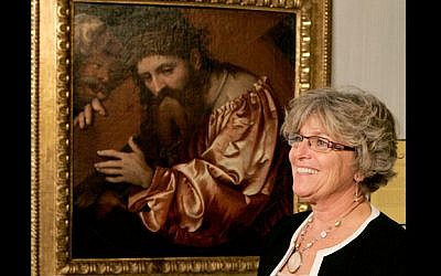 Chucha Barber, Chief Financial Officer of the Mary Brogan Museum, next to the recovered painting (photo credit: AP/Steve Cannon)