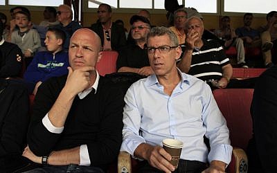 Former Dutch soccer player Jordi Cruyff (left) sits with the owner of Maccabi Tel Aviv soccer team Mitchell Goldhar during a game in Ashdod on Saturday (photo credit: Tsafrir Abayov/Flash90)