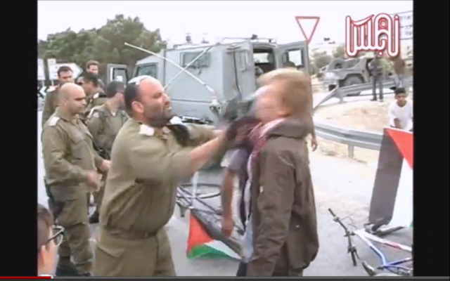 Lt.-Col. Shalom Eisner strikes a Danish protester with his rifle. (photo capture from ISM video on Youtube)