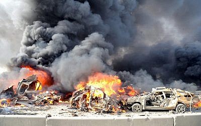 In this photo released by the Syrian official news agency SANA, flames and smoke raise from burning cars after two bombs exploded in Damascus on Thursday (photo credit: AP/PTI)