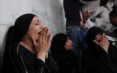 Egyptian women mourn the death of protesters in Cairo Wednesday (photo credit: AP/Mohammed Asad)