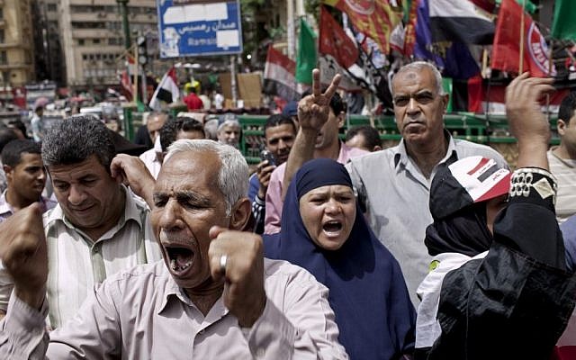Egyptian demonstrators gather to denounce the electoral success of Ahmed Shafiq, Mubarak's last prime minister, in Tahrir Square in Cairo, Egypt on Friday. (photo credit: Pete Muller/AP)