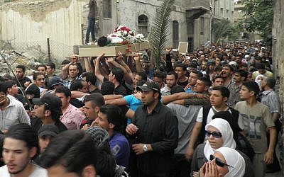 The funeral of a man killed in Damascus on Sunday (photo credit: AP) The funeral of a man killed in Damascus on Sunday (photo credit: AP)