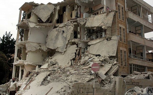 A building that was damaged after two bombs exploded near a military compound, in the city of Idlib, northwestern Syria, in April (photo credit: AP/SANA)