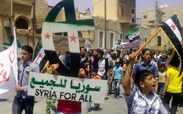 Protesters wave Syrian revolution flags in Aleppo in May 2012. Aleppo has been largely loyal to President Bashar Assad during the country's 17-month uprising. (photo credit: AP/Sham News Network, SNN)