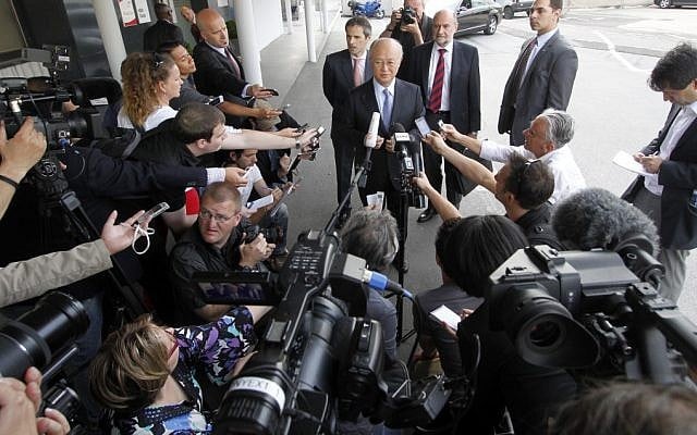 Director General of the International Atomic Energy Agency Yukiya Amano, center, speaks to the media before his flight to Iran at the Vienna International Airport on Sunday (photo credit: AP/Ronald Zak)