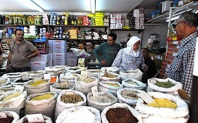 Moshe Charkhi (left) and Avraham Charkhi (center) at the Charkhi Deli in Tel Aviv's Levinsky spice market (photo credit: David Katz)