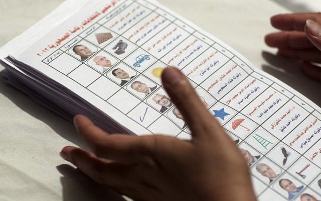 An Egyptian election official counts the ballots following the presidential election in Cairo, Egypt, Thursday. (photo credit: AP) An Egyptian election official counts the ballots following the presidential election in Cairo, Egypt, Thursday. (photo credit: AP)