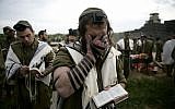 Illustrative: Religious soldiers of the Netzah Yehuda Battalion pray while completing the final stages of a 40 kilometer journey in 2010. (Abir Sultan/Flash90)