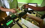 Illustrative image of someone purchasing medicinal marijuana in Tel Aviv. (Abir Sultan/Flash90)