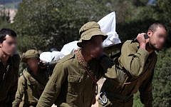 .Soldiers carrying the body of a soldier who committed suicide at a stalactite cave near Beit Shemesh in March 2011 (Photo credit: Abir Sultan/ Flash 90)