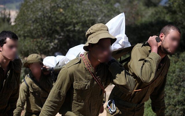 .Soldiers carrying the body of a soldier who committed suicide at a stalactite cave near Beit Shemesh in March 2011 (Photo credit: Abir Sultan/ Flash 90) .Soldiers carrying the body of a soldier who committed suicide at a stalactite cave near Beit Shemesh in March 2011 (Photo credit: Abir Sultan/ Flash 90)